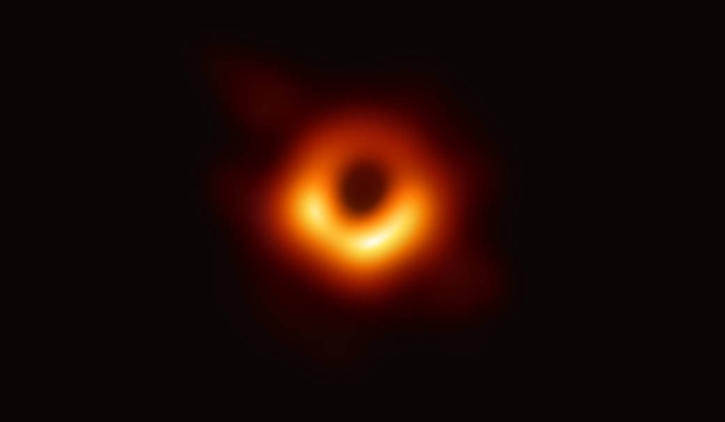 First Image of a Black Hole - The Event Horizon Telescope (EHT) — a planet-scale array of eight ground-based radio telescopes forged through international collaboration — was designed to capture images of a black hole. In coordinated press conferences across the globe, EHT researchers revealed that they succeeded, unveiling the first direct visual evidence of the supermassive black hole in the centre of Messier 87 and its shadow. The shadow of a black hole seen here is the closest we can come to an image of the black hole itself, a completely dark object from which light cannot escape. The black hole’s boundary — the event horizon from which the EHT takes its name — is around 2.5 times smaller than the shadow it casts and measures just under 40 billion km across. While this may sound large, this ring is only about 40 microarcseconds across — equivalent to measuring the length of a credit card on the surface of the Moon. Although the telescopes making up the EHT are not physically connected, they are able to synchronize their recorded data with atomic clocks — hydrogen masers — which precisely time their observations. These observations were collected at a wavelength of 1.3 mm during a 2017 global campaign. Each telescope of the EHT produced enormous amounts of data – roughly 350 terabytes per day – which was stored on high-performance helium-filled hard drives. These data were flown to highly specialised supercomputers — known as correlators — at the Max Planck Institute for Radio Astronomy and MIT Haystack Observatory to be combined. They were then painstakingly converted into an image using novel computational tools developed by the collaboration.